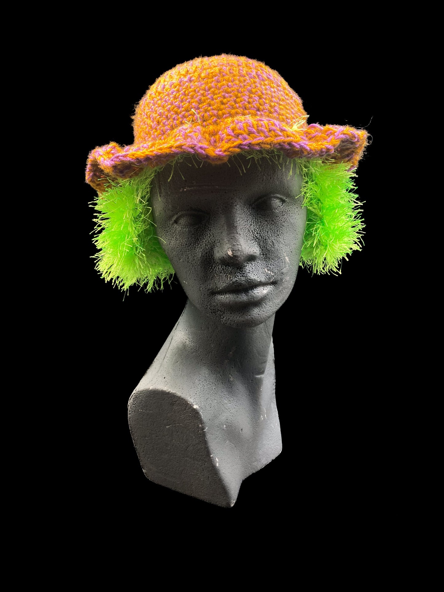 Handmade crochet headwear with neon green-yellow ear-covers, purple and mustard. Designed for a unisex fit, one size fits all.