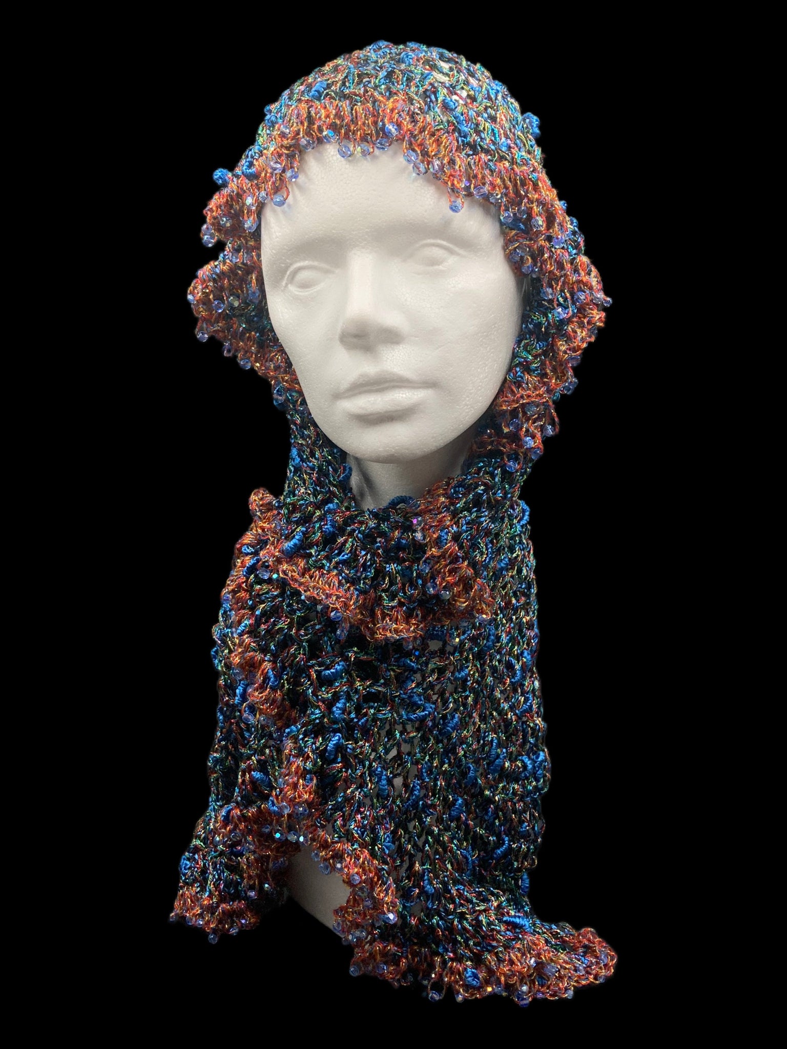 Handmade crochet Tarha in shimmering blue, copper, green, and black tones, with blue beads details and airy openwork, perfect for summer and wearable in various ways on the head and shoulders