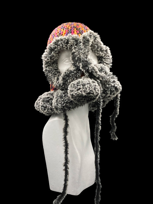 Handmade crochet balaclava with an open-eye and a waved-edge design, featuring a bold mix of black, orange, pink, blue and grey. Unisex, one size fits all