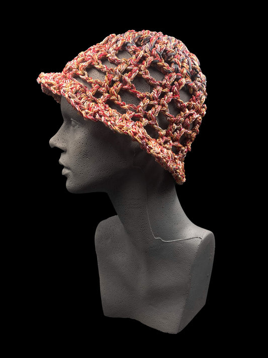 Handmade crochet bucket-hat, red, orange, yellow, with shades of blue and purple. Designed for a unisex fit, one size fits all.